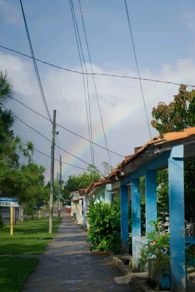 Cuba Rainbow A photo taken in a neighborhood in Cuba, with power lines overhead and a rainbow in the background
